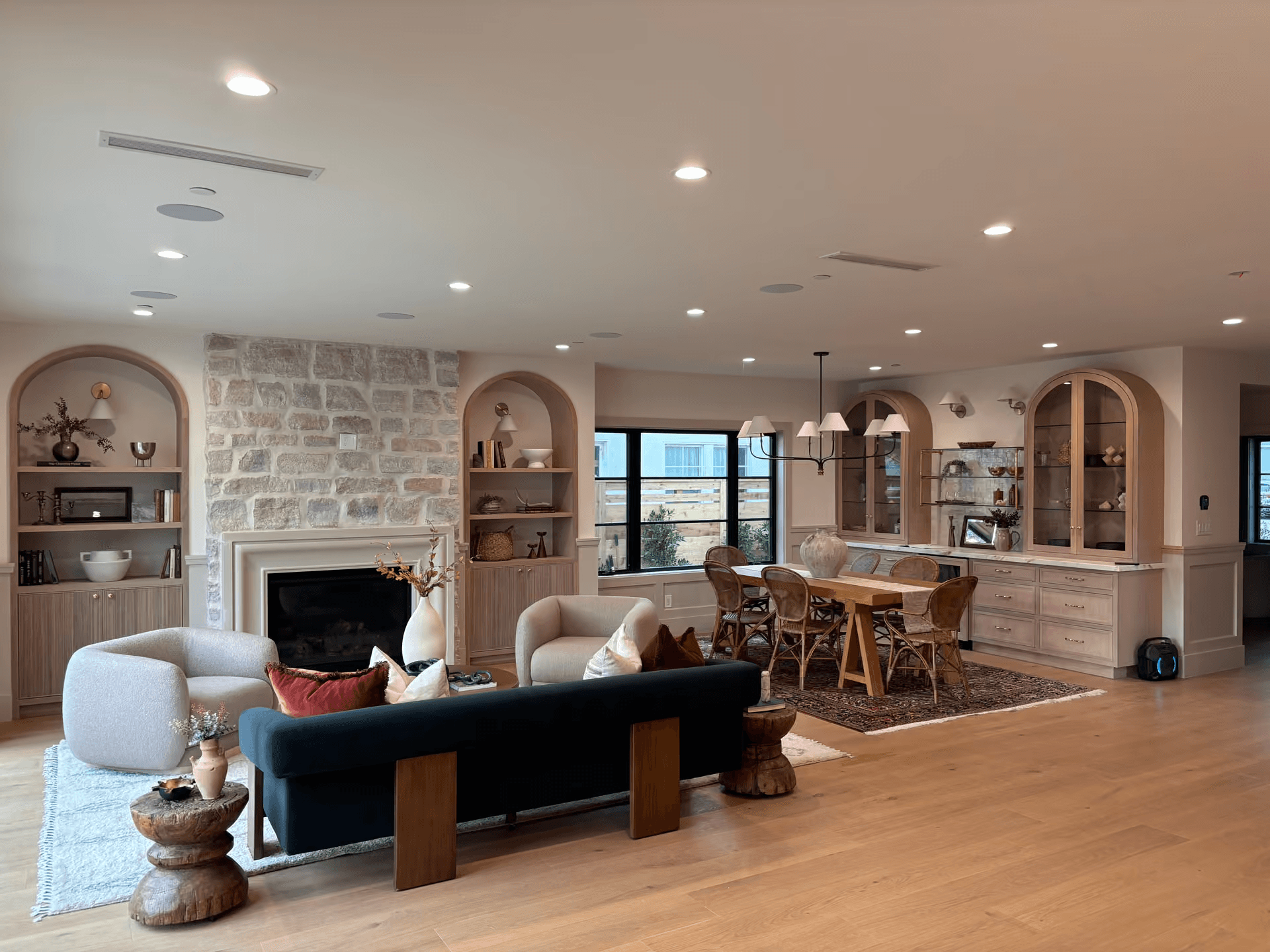 Custom wood cabinetry and millwork throughout a warm living and dining space
